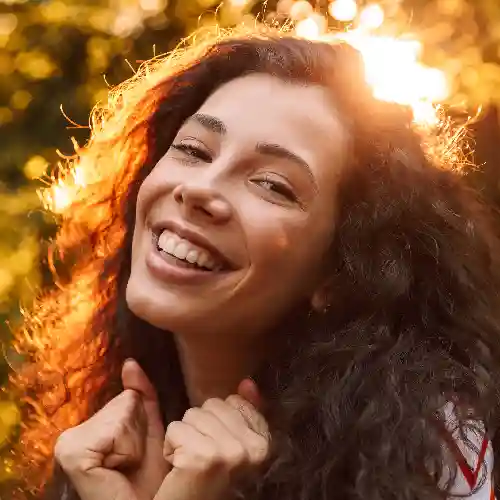 A girl smiling during sunset